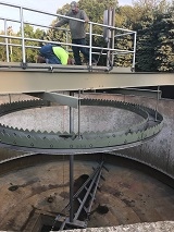 Workers inspecting water treatment equipment.