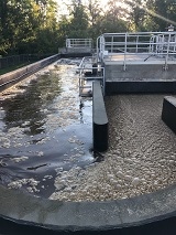 Wastewater treatment plant tanks during purification process.