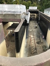 Construction site with deep foundation excavation.