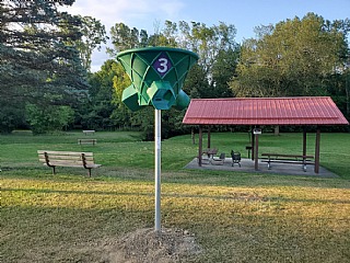 Disc golf basket number 3 in park setting.